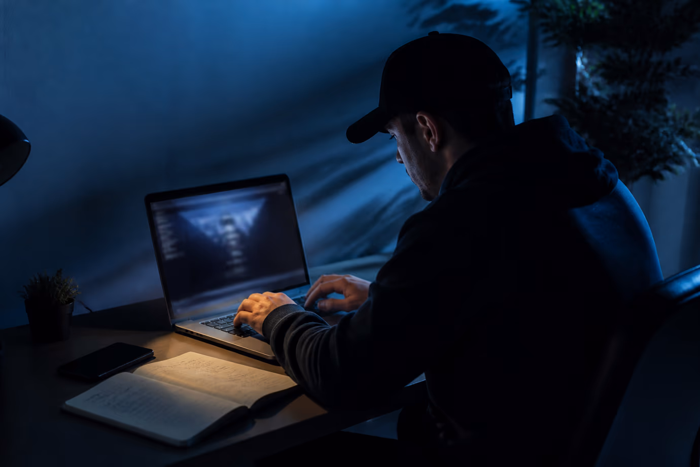 A user explores the Tor search engine while taking notes in a dimly lit room.